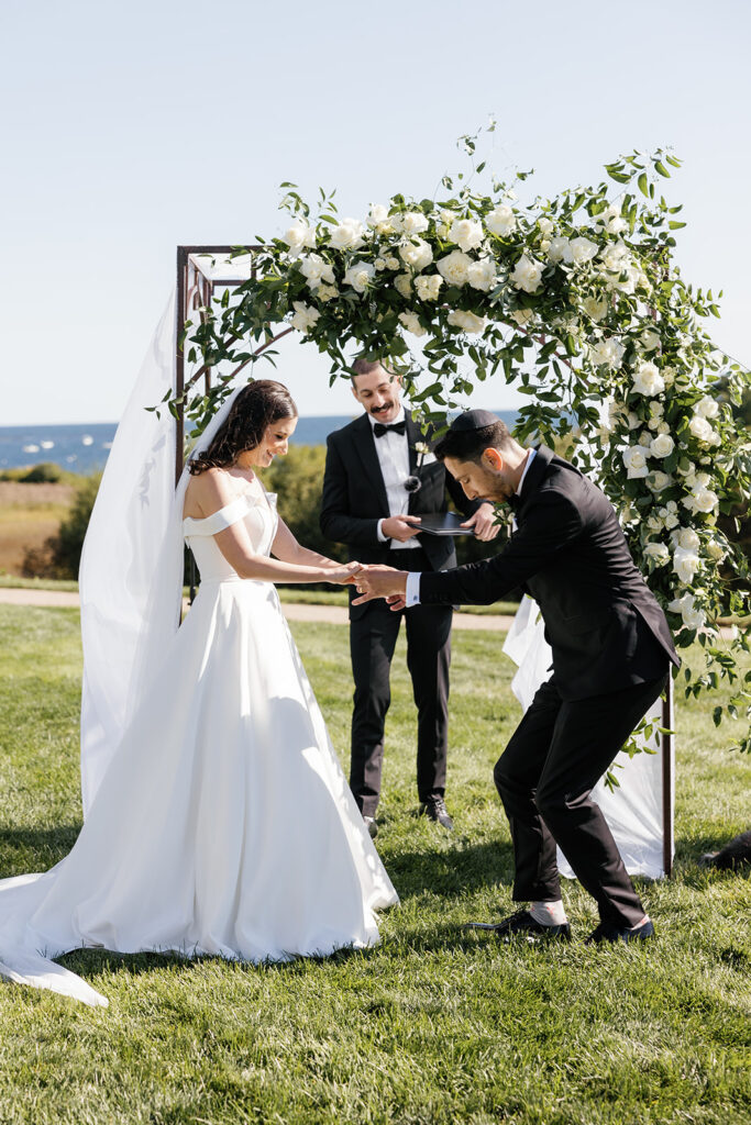 Bride and groom smashing a glass under the chuppah