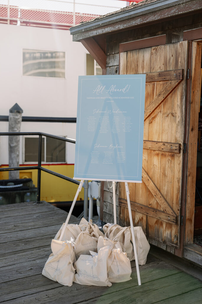 Welcome sign with welcome bags for a wedding welcome dinner sail in Portland