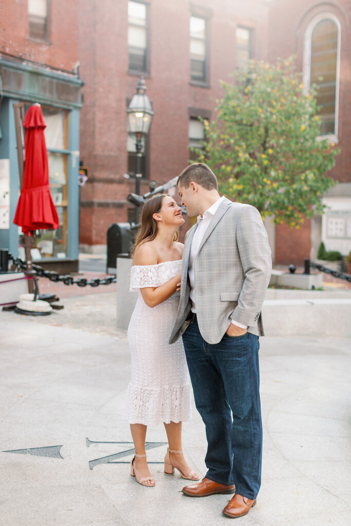 A couple embracing while standing in the alley in a city. 