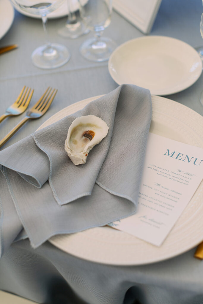 Blue napkins with oyster shell and menu