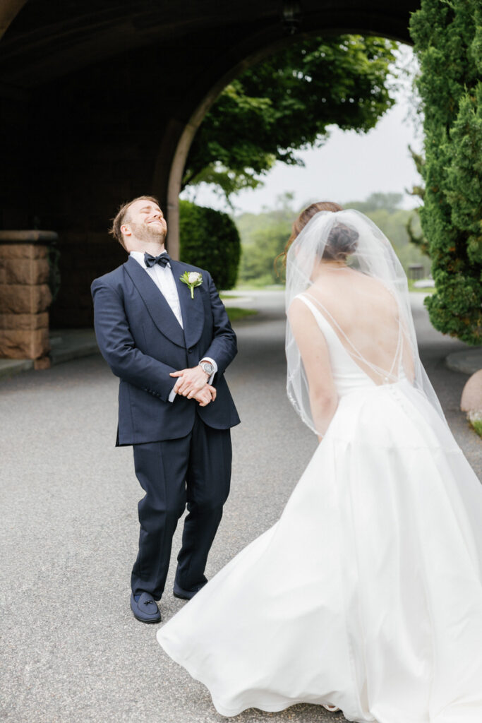 A bride and groom laughing as they do their first look 