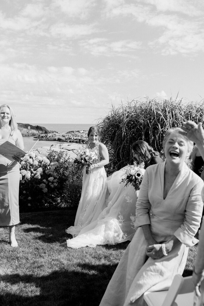 A bride outside with guests as they laugh and smile. 