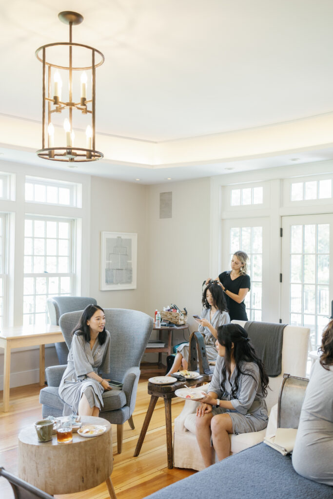 A bridal party chats as they wait to get their makeup done.